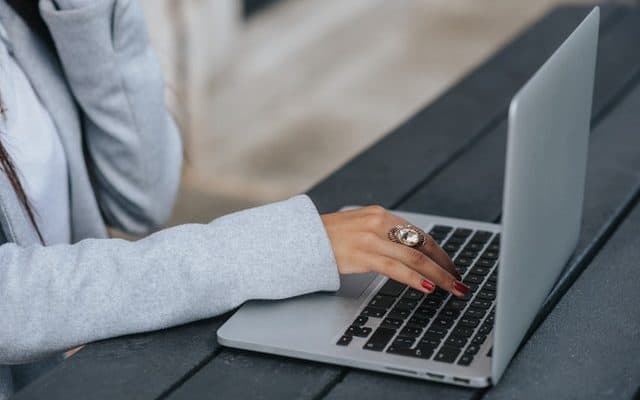 hand typing on laptop