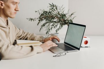 man typing on laptop