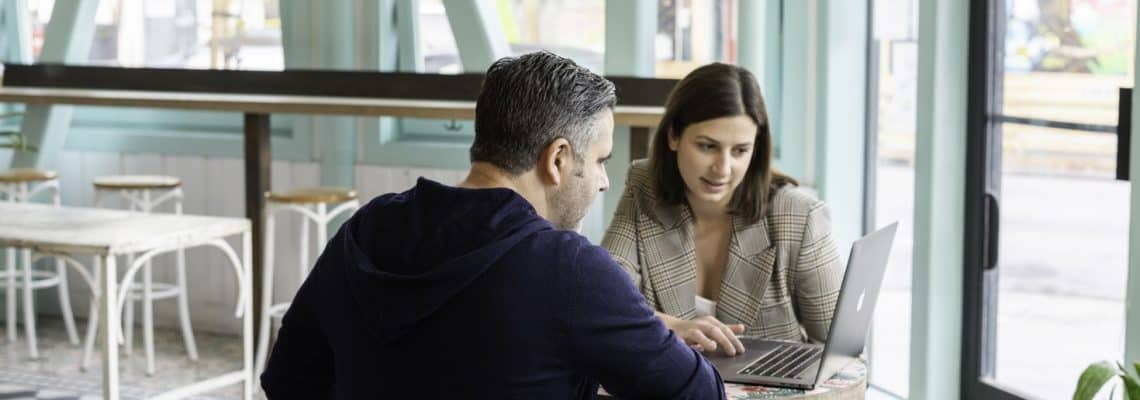 people looking at laptop